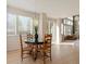 Bright and airy dining area with a modern light fixture and views of the living room at 7858 Oban Ct, Lone Tree, CO 80124
