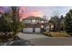 Beautiful two-story home with a three-car garage, brick accents, and a landscaped front yard at 7858 Oban Ct, Lone Tree, CO 80124