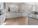 Classic kitchen featuring white cabinetry, ample counter space, and hardwood floors at 7858 Oban Ct, Lone Tree, CO 80124
