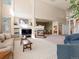 Open-concept living room with fireplace, high ceilings, and comfortable seating at 7858 Oban Ct, Lone Tree, CO 80124