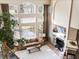 Bright living room featuring a cozy fireplace, large windows, and a comfortable seating area with modern decor at 7858 Oban Ct, Lone Tree, CO 80124