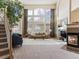 Bright, spacious living room with a large window, fireplace, and comfortable seating arrangement at 7858 Oban Ct, Lone Tree, CO 80124