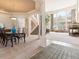 Open concept view of staircase, dining area and large living room with fireplace and picture window at 7858 Oban Ct, Lone Tree, CO 80124