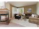 Inviting living room featuring a fireplace, plush seating, and abundant natural light from the large windows at 7858 Oban Ct, Lone Tree, CO 80124