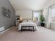 Serene main bedroom with neutral colors, bench, decorative wall art, and ample natural light for relaxation at 7858 Oban Ct, Lone Tree, CO 80124