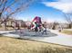 Colorful community playground equipped with slides, climbing structures, and soft surfacing for safe play at 7858 Oban Ct, Lone Tree, CO 80124