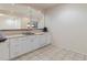 Stylish wet bar with white cabinetry, tile backsplash, and convenient sink area at 7858 Oban Ct, Lone Tree, CO 80124