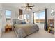Bright bedroom featuring large windows, a ceiling fan, and calming neutral tones at 5351 Warrior St, Frederick, CO 80504