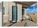 Welcoming front porch with seating area and a vibrant blue door at 5351 Warrior St, Frederick, CO 80504