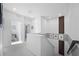 Bright hallway with white walls, carpeted floors, modern wood slat accent wall at 5351 Warrior St, Frederick, CO 80504