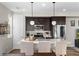 Stylish kitchen featuring dark cabinets, stainless steel appliances, and pendant lighting at 5351 Warrior St, Frederick, CO 80504