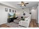 Comfortable living room with a large sectional couch, wall decor, and access to the staircase at 5351 Warrior St, Frederick, CO 80504