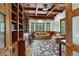 This home office features custom built-in shelving, coffered ceilings, and generous natural light at 219 Glen Eagle Loop, Breckenridge, CO 80424