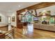 Open-concept living room featuring wood floors, a stone fireplace, and large windows at 219 Glen Eagle Loop, Breckenridge, CO 80424