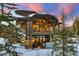 Home exterior featuring a back deck with a hot tub surrounded by snowy trees at 219 Glen Eagle Loop, Breckenridge, CO 80424