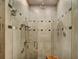 Modern shower with beige tiling, decorative accents, and glass doors, creating a luxurious spa-like experience at 219 Glen Eagle Loop, Breckenridge, CO 80424