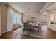 Sunlit dining room featuring hardwood floors, chandelier, and staircase views at 6317 Ruby Hill Dr, Erie, CO 80516
