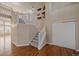 Bright foyer with wood floors, staircase, and decorative luggage wall hangings at 6317 Ruby Hill Dr, Erie, CO 80516
