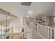 Upstairs hallway featuring neutral walls, carpeting and white railings at 6317 Ruby Hill Dr, Erie, CO 80516