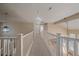 Hallway view from upstairs featuring neutral colored walls, carpeting and white railings at 6317 Ruby Hill Dr, Erie, CO 80516
