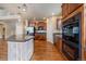 Kitchen with a center island, stainless steel appliances, and wood cabinets, offering a functional layout at 6317 Ruby Hill Dr, Erie, CO 80516