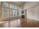 Bright living room with hardwood floors, fireplace, and decorative stained glass windows at 6317 Ruby Hill Dr, Erie, CO 80516