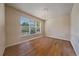 Living room featuring hardwood floors, a large window and classic chandelier at 6317 Ruby Hill Dr, Erie, CO 80516