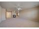 Spacious living room with a fireplace and ceiling fan for comfortable living at 6317 Ruby Hill Dr, Erie, CO 80516