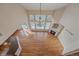 Open concept living room showcases stained glass windows, a fireplace, and wood flooring at 6317 Ruby Hill Dr, Erie, CO 80516