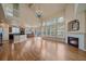 Open living area with kitchen, fireplace, chandelier, large windows, and hardwood flooring at 6317 Ruby Hill Dr, Erie, CO 80516