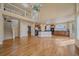Open-concept living room with kitchen, staircase, hardwood floors, and bright natural lighting at 6317 Ruby Hill Dr, Erie, CO 80516