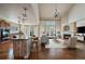 Staged living room with hardwood floors, fireplace, and a kitchen island visible in the background at 6317 Ruby Hill Dr, Erie, CO 80516