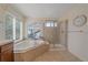 Relaxing main bathroom featuring a soaking tub and a separate glass shower at 6317 Ruby Hill Dr, Erie, CO 80516