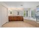 Bright main bathroom with a double vanity, soaking tub, and natural light at 6317 Ruby Hill Dr, Erie, CO 80516