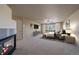 Main bedroom featuring carpet, fireplace, ceiling fan, window with blinds, bed and nightstands at 6317 Ruby Hill Dr, Erie, CO 80516