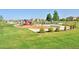 A bright and inviting community playground set in a well-maintained grassy area at 6317 Ruby Hill Dr, Erie, CO 80516