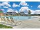 Community pool with lounge chairs and well-maintained landscaping offering a relaxing outdoor amenity at 6317 Ruby Hill Dr, Erie, CO 80516