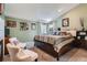 Spacious bedroom with striped bedding, sitting chairs, decorative wall hangings and a window at 13495 Shiloh Rd, Conifer, CO 80433