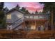 Charming home with a spacious deck and wooden fence, set against a backdrop of lush trees at 13495 Shiloh Rd, Conifer, CO 80433
