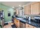 Well-lit kitchen boasts stainless appliances, granite countertops, and natural wood cabinets at 13495 Shiloh Rd, Conifer, CO 80433