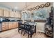 Charming kitchen with breakfast nook, wood floors, stainless steel appliances and hanging light fixture at 13495 Shiloh Rd, Conifer, CO 80433