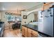 View of dining area with decorative plates and a stainless steel refrigerator in this home's eat-in kitchen at 13495 Shiloh Rd, Conifer, CO 80433