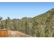 An expansive view of the rolling forested terrain and clear blue skies from the edge of the property at 13495 Shiloh Rd, Conifer, CO 80433
