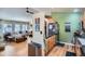 View of kitchen with stainless steel appliances that leads to a living room with a large sectional couch at 13495 Shiloh Rd, Conifer, CO 80433