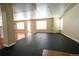 Spacious basement area with large windows, hardwood and black exercise flooring at 18112 E Dorado Ave, Centennial, CO 80015