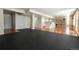 Open basement floor plan with a wet bar, hardwood floors, and black exercise flooring at 18112 E Dorado Ave, Centennial, CO 80015
