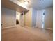 Carpeted bedroom shows one doorway into the ensuite bathroom and another into the hallway at 18112 E Dorado Ave, Centennial, CO 80015
