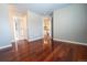 Bedroom featuring hardwood floors and access to the hallway at 18112 E Dorado Ave, Centennial, CO 80015