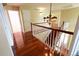 Hallway featuring hardwood floors, a hanging chandelier, and a staircase with wood railing at 18112 E Dorado Ave, Centennial, CO 80015