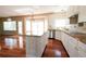 Bright kitchen with white cabinetry, granite countertops, and a center island at 18112 E Dorado Ave, Centennial, CO 80015